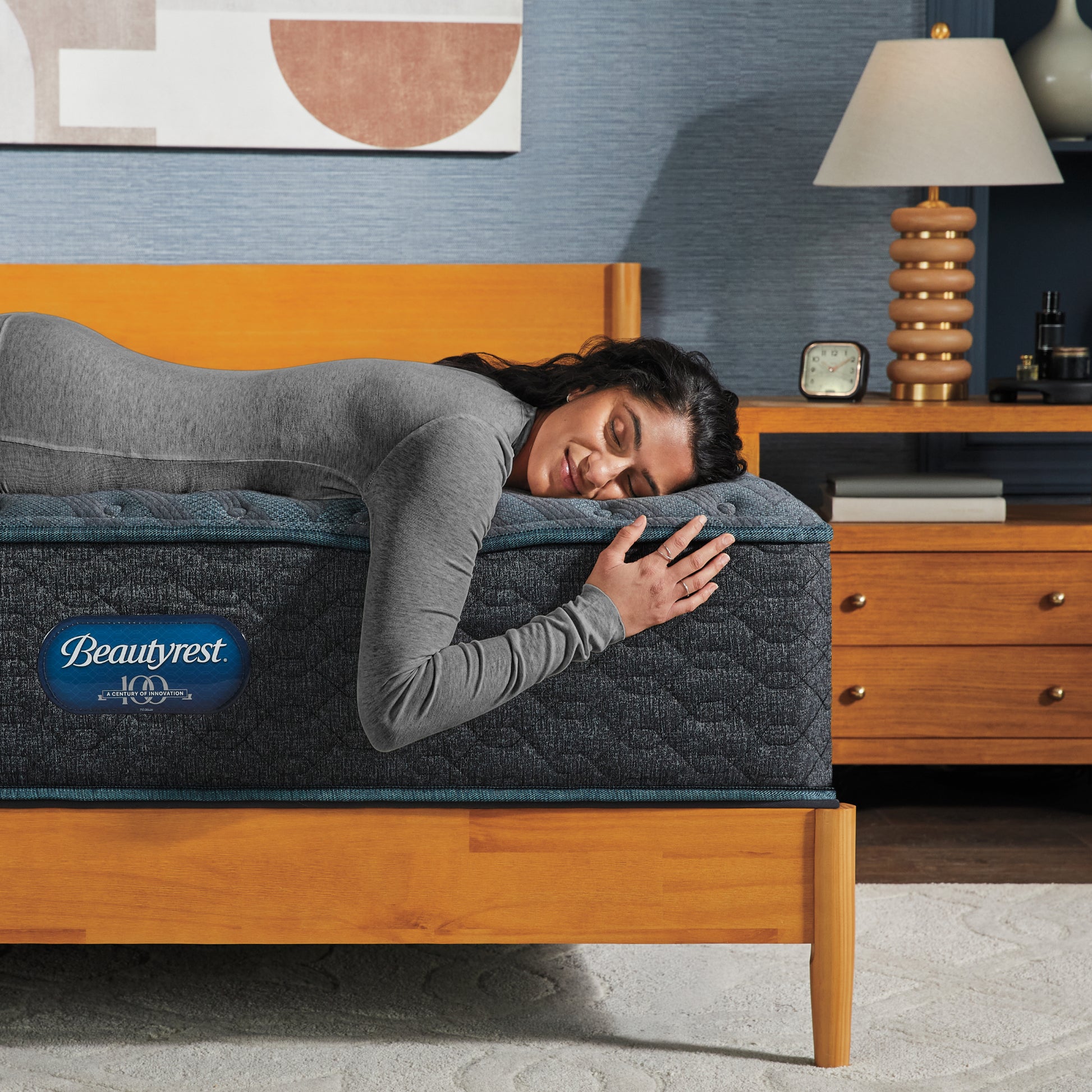 Woman laying on the edge of a Beautyrest mattress asleep